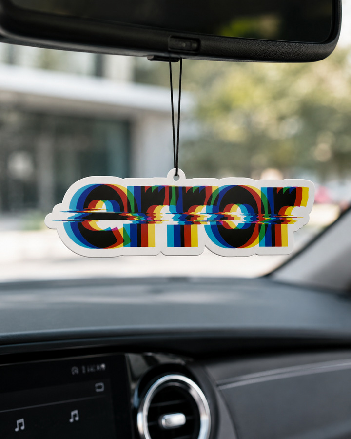 A car air freshener hanging from a rearview mirror inside a vehicle. The clear acrylic word-art reads 'ERROR' with a glitch-style rainbow distortion effect.